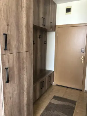 a locker room with wooden cabinets and a door at ELIT 2 APART HOTEL in Sunny Beach