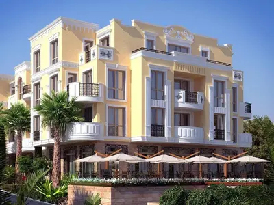 a yellow building with umbrellas in front of it at FLORENCE SUITES APART HOTEL in Sveti Vlas