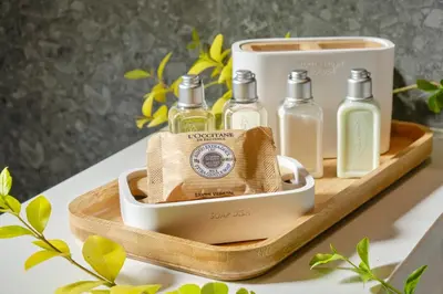 a wooden tray with three bottles on a table at Viva Mare Beach Hotel by Santa Marina in Sozopol
