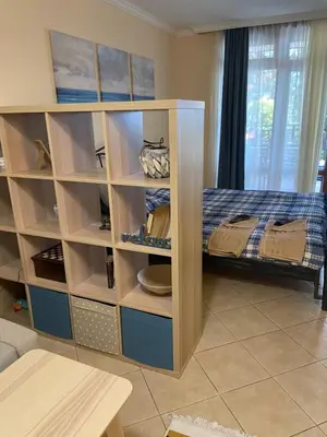 a room with a bunk bed with shelves at Tiny Bijou Sea View studio - Santa Marina - Sozopol in Sozopol