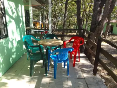 a group of colorful chairs and a table on a porch at Бунгала Дъбрава in Shkorpilovtsi