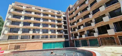 a swimming pool in front of a building at Dimi's River Park in Sunny Beach