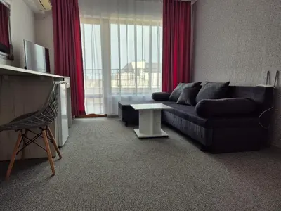a living room with a couch and a table at Dani beach Sozopol in Sozopol