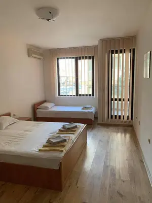 a bedroom with two beds and two windows at Sozopol Dreams - Apartment №41 in Sozopol