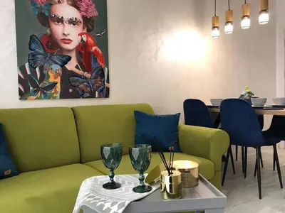 a living room with a green couch and a table at Аpartment Bella Vista in Obzor