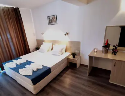 a bedroom with a bed with towels on it at Hotel Largo Beach in Sunny Beach