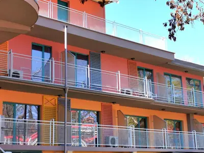 an orange building with balconies on the side of it at Hotel Largo Beach in Sunny Beach