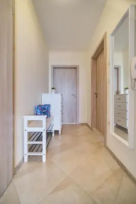 a hallway with a refrigerator and a table in a room at Summertime in Varna South Bay Beach Residence in Varna City