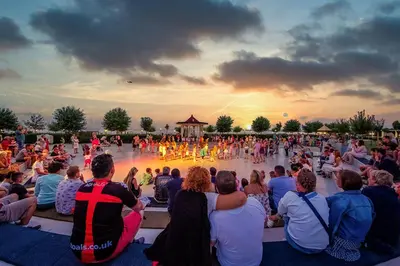 a group of people sitting in a crowd watching a concert at Premier Fort Beach Luxury in Sveti Vlas