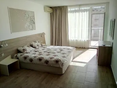 a bedroom with a bed and a large window at Silver Beach A98 in Byala