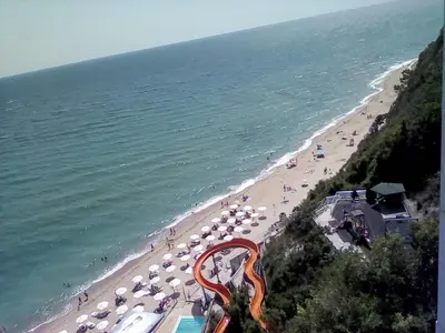 a beach with umbrellas and a bunch of people at Silver Beach A98 in Byala