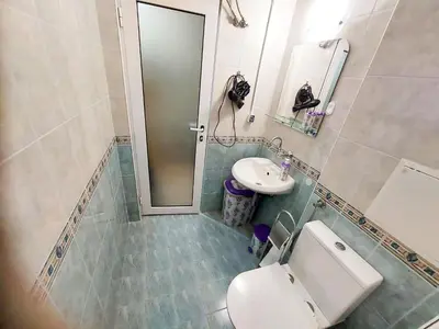 a bathroom with a toilet and a sink at Апартамент Кънтри-Лариса in Pomorie