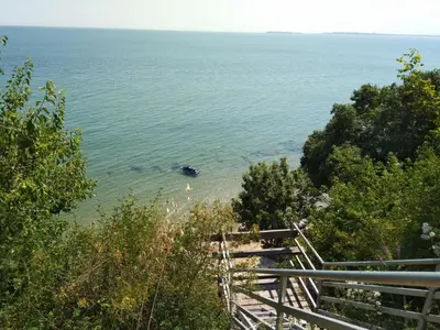 a view of the ocean with a boat in the water at Apartmán Alex beach s nádherným panoramatickým výhledem na moře in Sveti Vlas