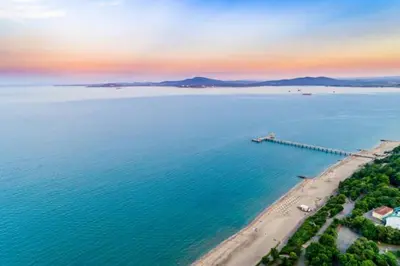 an aerial view of a large body of water with a pier at Портхаус in Burgas City