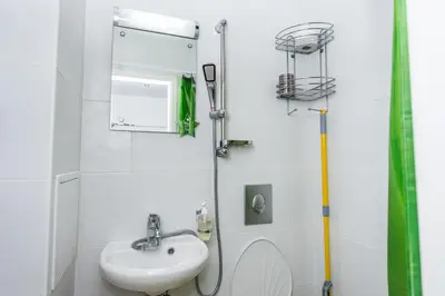 a bathroom with a sink and a toilet at Портхаус in Burgas City