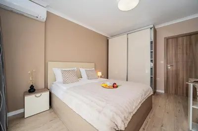 a bedroom with a bed with a bowl of fruit on it at Comfy luxury center apartment in Varna City