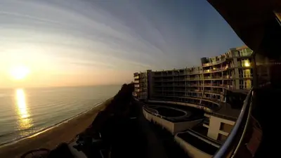 a view of a hotel and the ocean at sunset at Silver beach Studio Byala in Byala