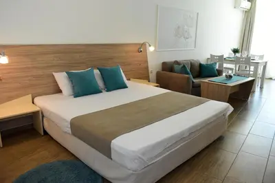 a bedroom with a large bed and a couch at Silver beach Studio Byala in Byala