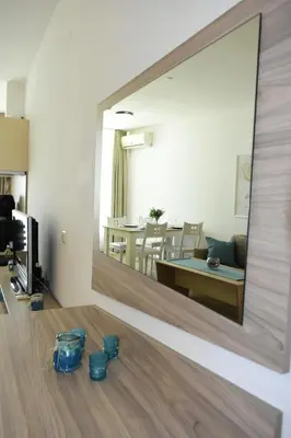 a mirror on the wall of a living room at Silver beach Studio Byala in Byala