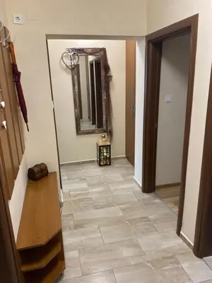 a hallway with a tile floor and a mirror at Luxury family apartament in Burgas City