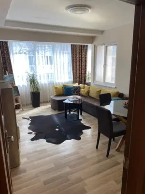 a living room with a couch and a table at Luxury family apartament in Burgas City