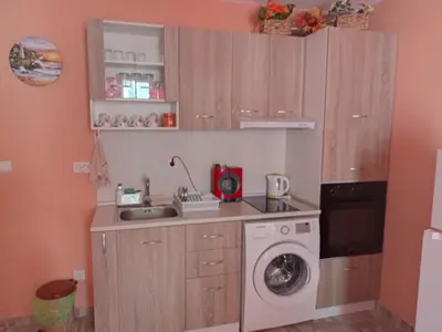a kitchen with a washing machine and a washer at Апартамент Spirit in Nesebar