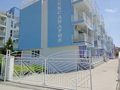 a blue building with a gate in front of it at Апартамент Spirit in Nesebar