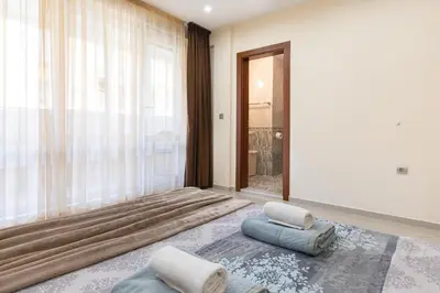 a room with two pillows and a large window at BeCentral! by RV Apartments in Varna City