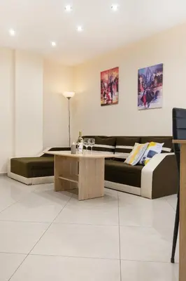 a living room with a bed and a coffee table at BeCentral! by RV Apartments in Varna City