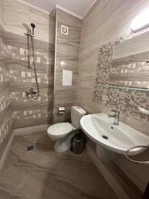 a bathroom with a toilet and a sink at Вила Quiet Bay in Sozopol