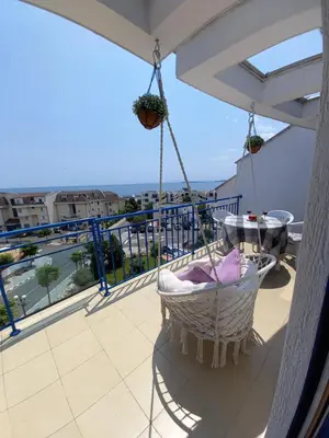 a balcony with a hammock and a view of the ocean at Vega Village Ap A8 in Sveti Vlas