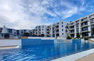 a swimming pool in front of some apartment buildings at Vega Village Ap A8 in Sveti Vlas