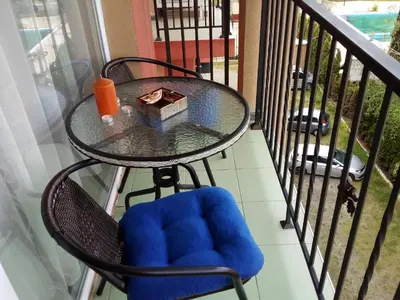 a table and chair with a candle on a balcony at SUNNY VIEW CENTRAL 3401 Studio Sunny Beach in Sunny Beach