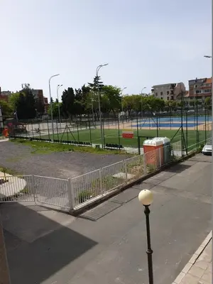a fence in a park with a parking lot at Анси in Pomorie