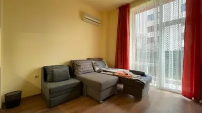 a room with a couch and a chair and a window at AFRODITA I 108 Studio Sunny Beach in Sunny Beach