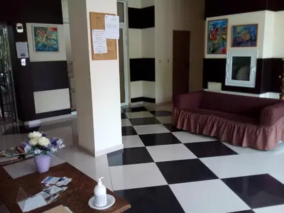 a lobby with a couch and a checkered floor at AFRODITA I 108 Studio Sunny Beach in Sunny Beach