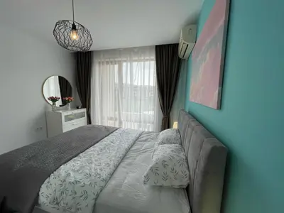 a bedroom with a large bed and a mirror at Prestige Fort Beach - Premium apartments in Sveti Vlas