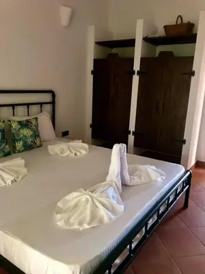 a bed with two white towels on top of it at Villa Oasis етаж1 in Lozenets