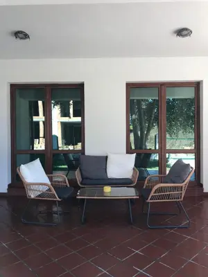 a patio with two chairs and a couch and a table at Villa Oasis етаж1 in Lozenets