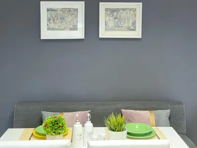 a dining room table with green plates on it at Апартамент Компас in Burgas City