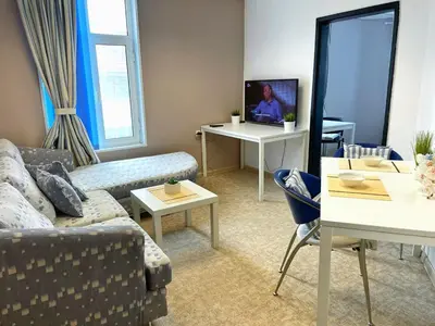 a living room with a couch and a table at Апартамент Компас in Burgas City