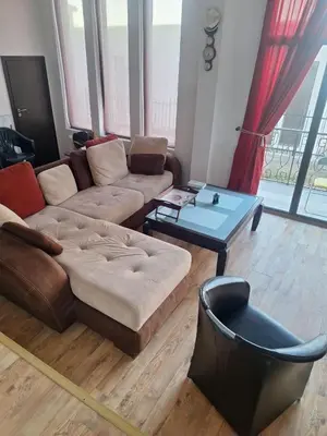 a living room with a couch and a coffee table at Sea view apartment in Tsarevo