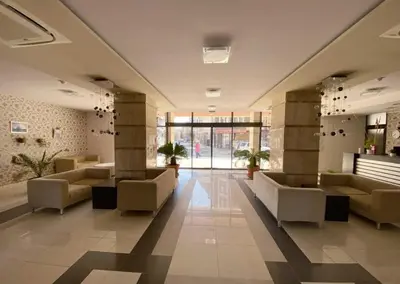a lobby with couches and tables in a building at Студио-
