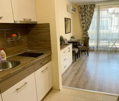 a kitchen with a sink and a table in a room at Студио-