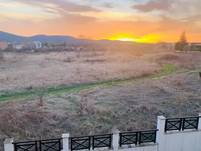 a view of a field with the sunset in the background at Apartment at St. Nicholas Complex-Igora in Chernomorets
