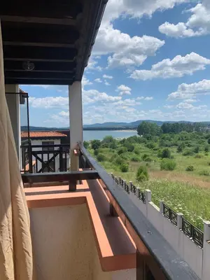 a balcony with a view of a lake at Apartment at St. Nicholas Complex-Igora in Chernomorets