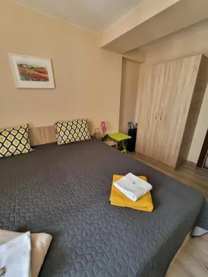 a bedroom with a bed with a tray on it at Бутикови апартаменти Емона in Ravda