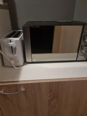 a microwave oven sitting on top of a counter at Бутикови апартаменти Емона in Ravda
