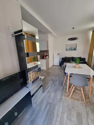 a living room with a table and a couch at Бутикови апартаменти Емона in Ravda