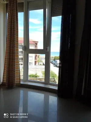 a room with a window with a view of the ocean at Студио in Lozenets